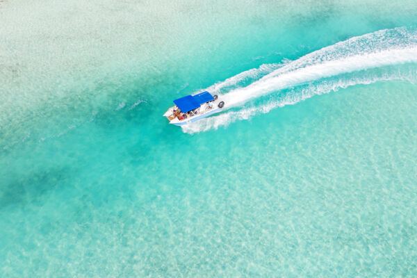 Turks and Caicos boat cruise in turquoise water. 