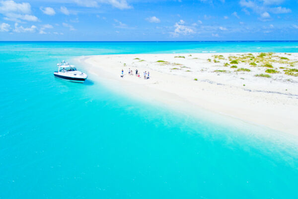 Aerial view of the beach at Fort George Cay and a private yacht charter