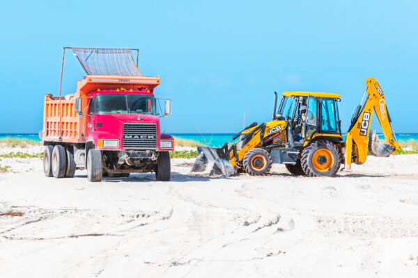 Dump truck and JCB 3DX backhoe at Leeward Beach on Providenciales
