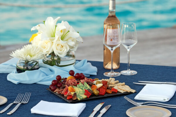 Table near the ocean with wine and appetizers 