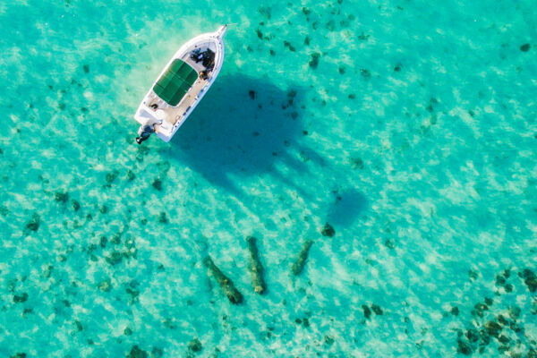 Small powerboat and submerged cannons at Fort George Cay