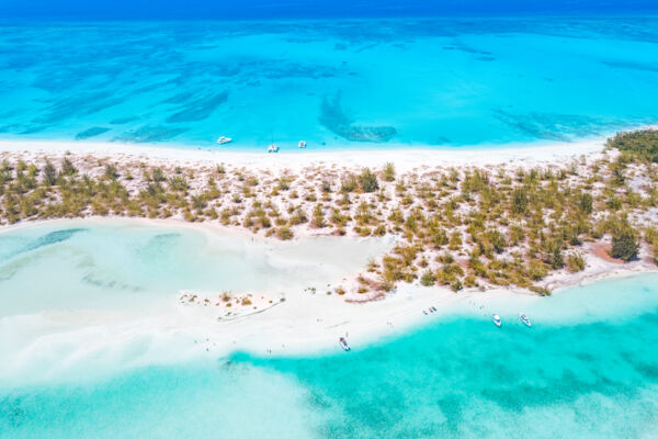 Overhead view of a beautiful beach surrounded by turquoise water.