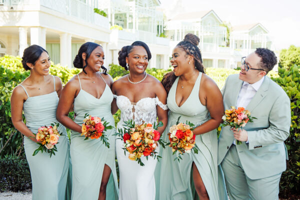 Bridal party holding colorful bouquets.
