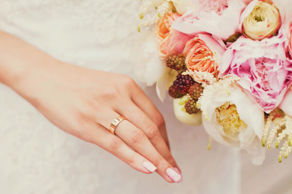 Bride with ring and flower bouquet