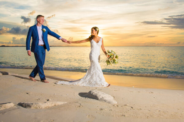 Bride and groom on Grace Bay Beach at sunset