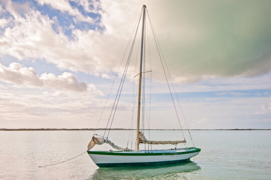 Small Caicos Sloop on the calm water at Chalk Sound