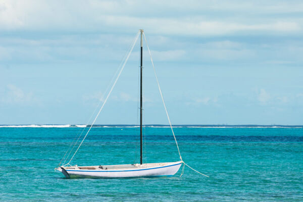 Caicos Sloop moored off the beach at Blue Hills settlement on Providenciales