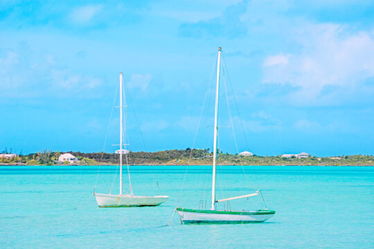Two small Caicos Sloops anchored in Chalk Sound lagoon