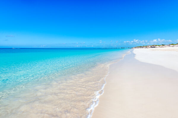 Blue sky, clear ocean water and white sand at Water Cay Beach