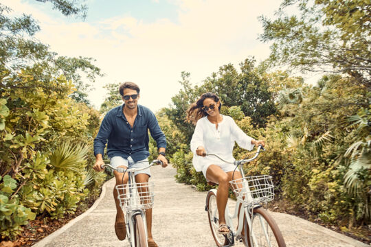 Couple cycling on a trail on Parrot Cay