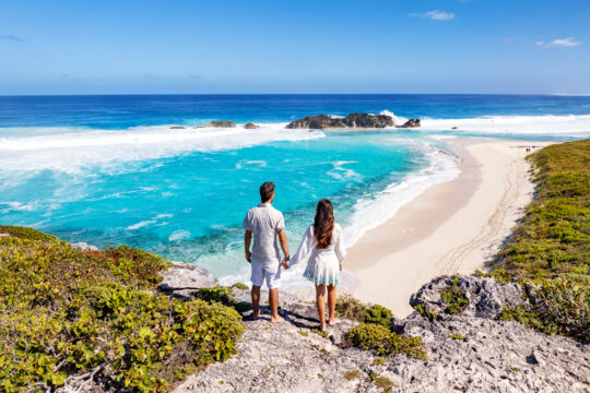 Couple on the cliffs overlooking Mudjin Harbour, Middle Caicos.