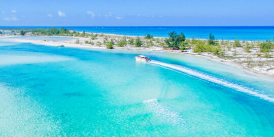 Tour boat cruising into Half Moon Bay lagoon at Water Cay