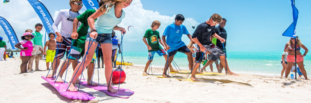 Children big foot racing on Long Bay Beach