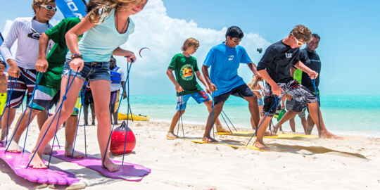 Children big foot racing on Long Bay Beach