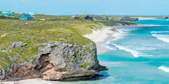 Cliffs by the sea at Mudjin Harbour, Middle Caicos, with small resort villas perched on top.