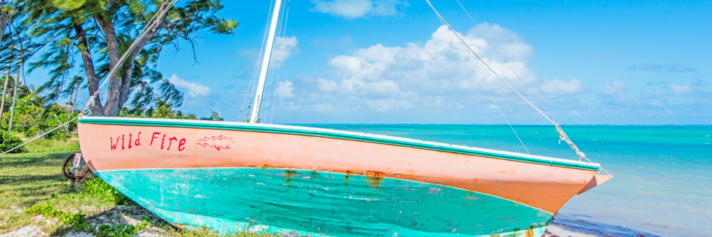 The small Wild Fire Caicos Sloop on the beach at Blue Hills