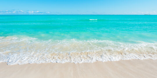 Wave on the beach and turquoise ocean at Cedar Point 