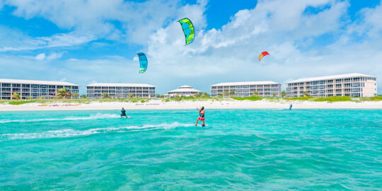 Kiteboarders on the beautiful turquoise waters fronting the East Bay Resort