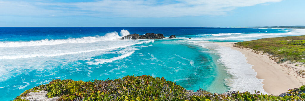 Waves crashing onto Dragon Cay, a small island in the bay at Mudjin Harbour, Middle Caicos.