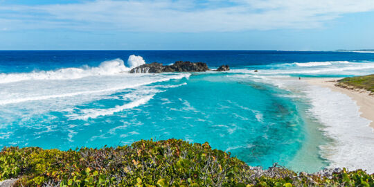 Waves crashing onto Dragon Cay, a small island in the bay at Mudjin Harbour, Middle Caicos.