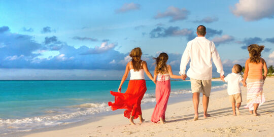 Family photography session on Grace Bay Beach at sunset