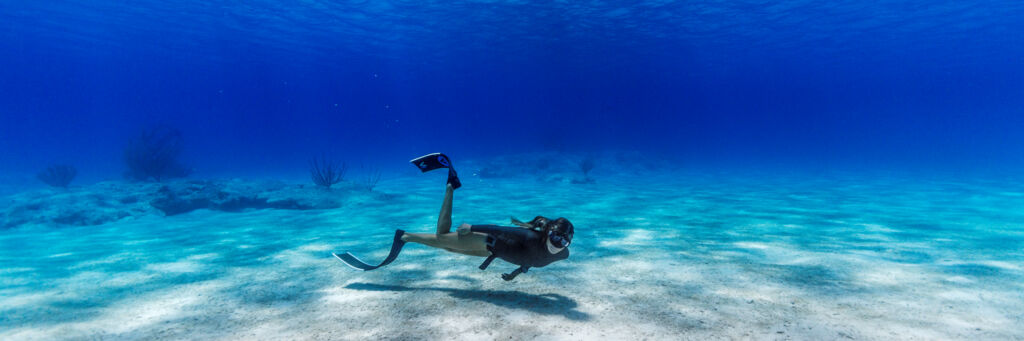 Freediver in clear ocean water at Malcolm's Road Beach on Providenciales