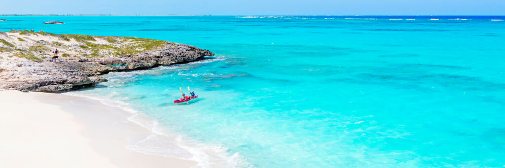 A pink kayak in the water off a small cay near Middle Caicos.