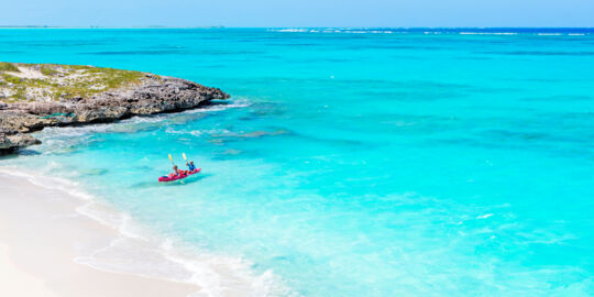 A pink kayak in the water off a small cay near Middle Caicos.