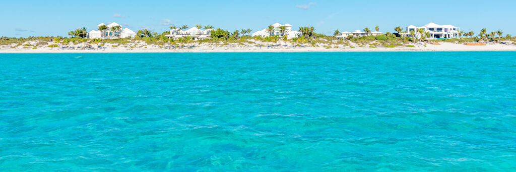 Turquoise water and luxury homes at Long Bay Beach in the Turks and Caicos