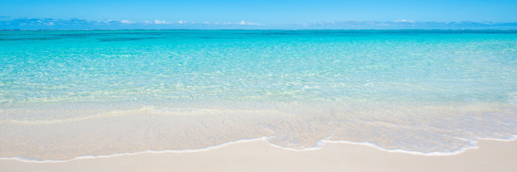 The calm and clear ocean water at Pumpkin Bluff Beach on North Caicos