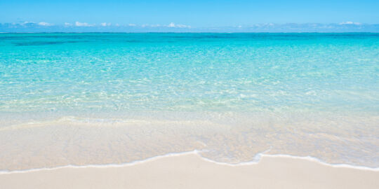 The calm and clear ocean water at Pumpkin Bluff Beach on North Caicos