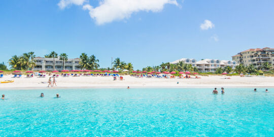 People enjoying the spectacular Grace Bay Beach in the Turks and Caicos