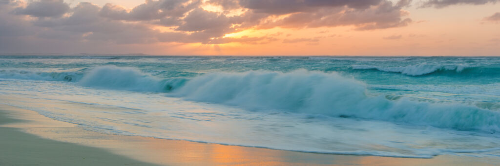 Sunset and breaking waves at Leeward Beach in the Turks and Caicos