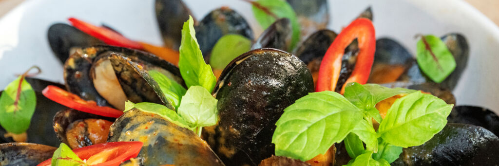 Plate of red curry mussels at a Turks and Caicos restaurant.
