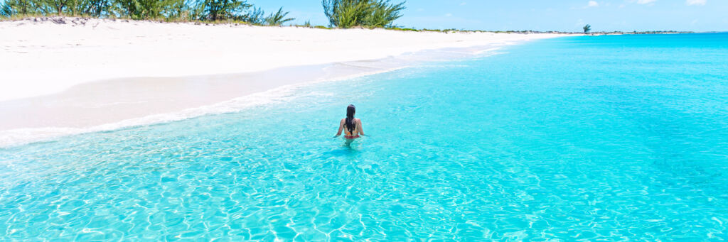 Person in clear ocean water at Water Cay in the Turks and Caicos