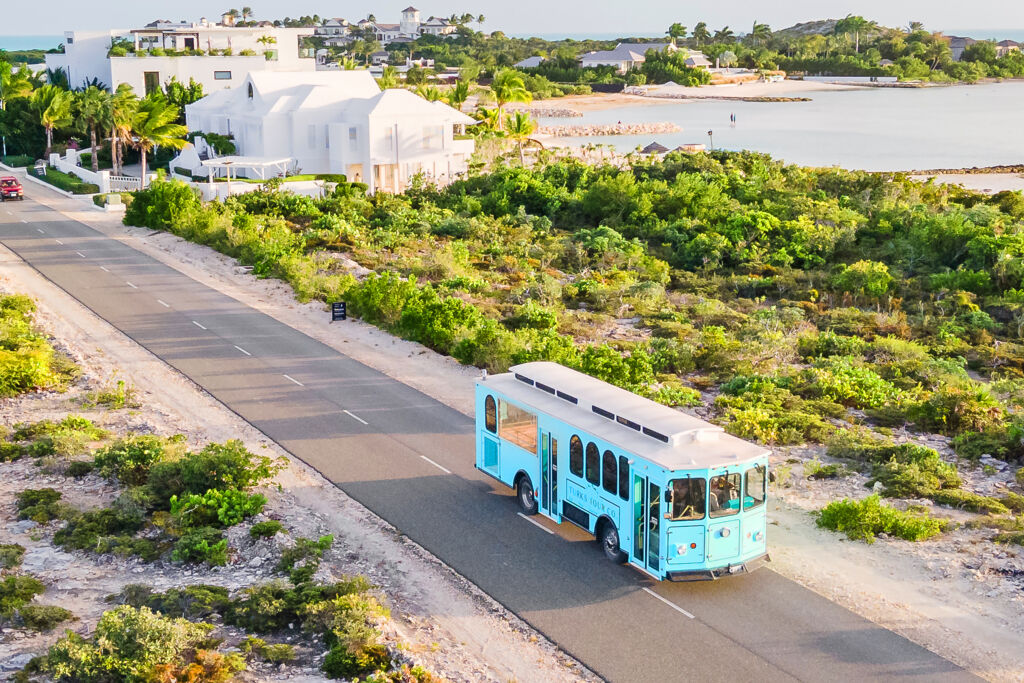 Drone image of a tour bus on a quiet coastal road, Turks and Caicos. 