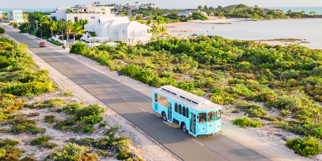 Drone image of a tour bus on a quiet coastal road, Turks and Caicos. 