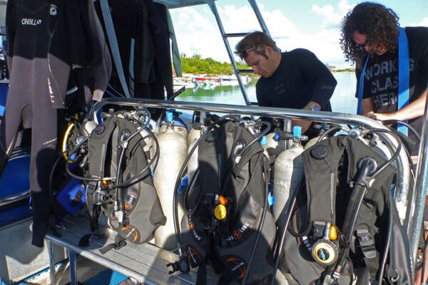 Setting up scuba diving equipment on a dive boat on Providenciales