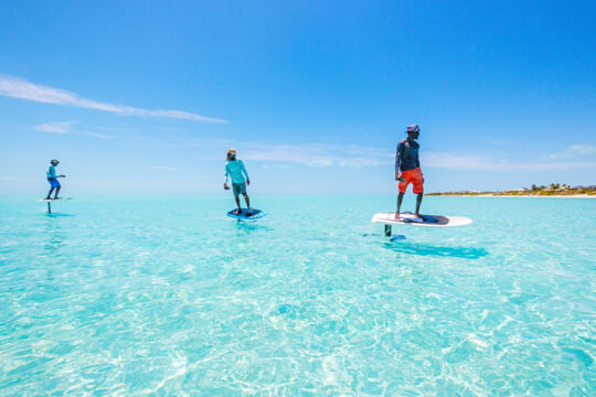 E-foil surfers in clear turquoise water in the Turks and Caicos