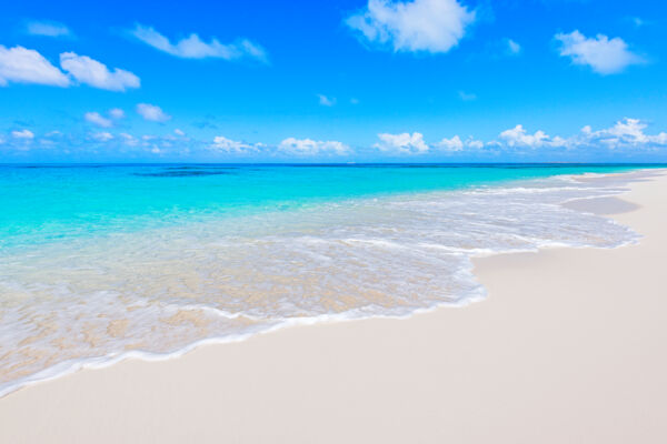 The water and beach at North Bay, Salt Cay with clouds in the sky.