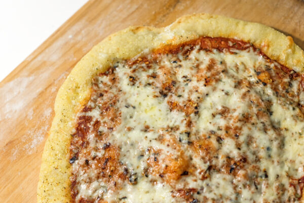 A gourmet pizza on a wood pizza peel in the Turks and Caicos