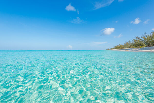 Turquoise water and blue sky at Governor's Beach in the Turks and Caicos