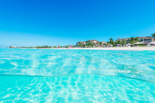 Over-under of the clear ocean water at Grace Bay Beach