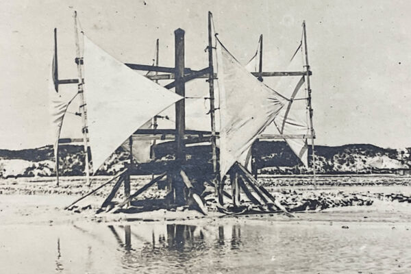 Historical photo of a horizontal windmill pump in the sea salt salinas on Grand Turk