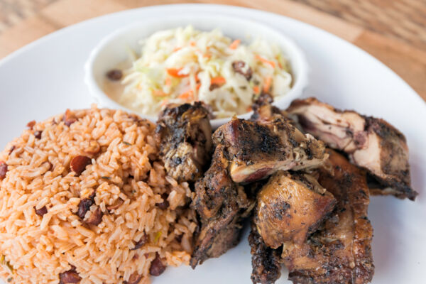 Jerk chicken with pea n' rice and coleslaw