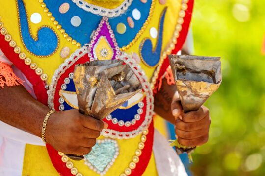 Turks and Caicos junkanoo musician with cowbell shakers. 