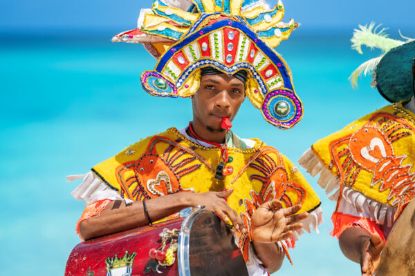 Turks and Caicos junkanoo player with drum and costume. 