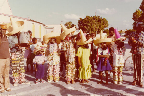 Archival image of junkanoo masqueraders in costume.
