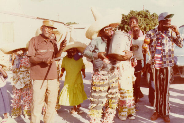 Archival image of junkanoo masqueraders in costume.