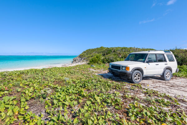 White Land Rover Discovery on the shore at Pumpkin Bluff Beach on North Caicos